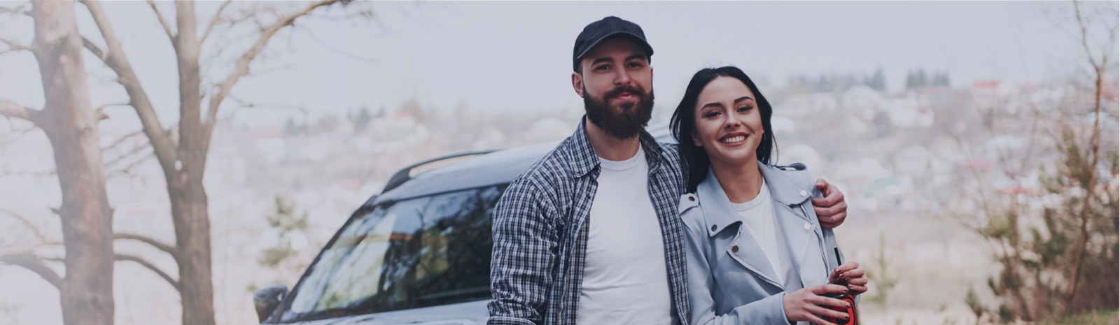 Man and woman in front of a new car